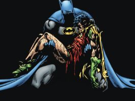Batman holding the lifeless body of Jason Todd Robin after the Joker's attack