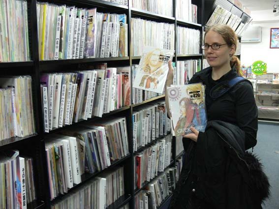 A reader browsing manga in a Tokyo shop