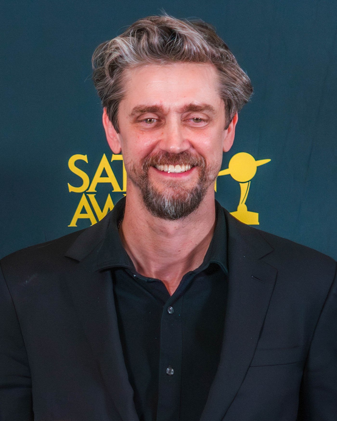 Andy Muschietti smiling on a red carpet at an awards show