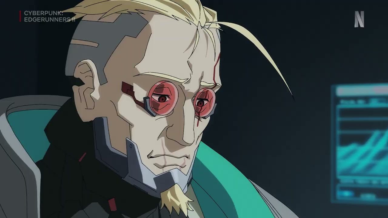 A frame from the Cyberpunk: Edgerunners 2 teaser showing a figure with cybernetic eyes beside a monitor