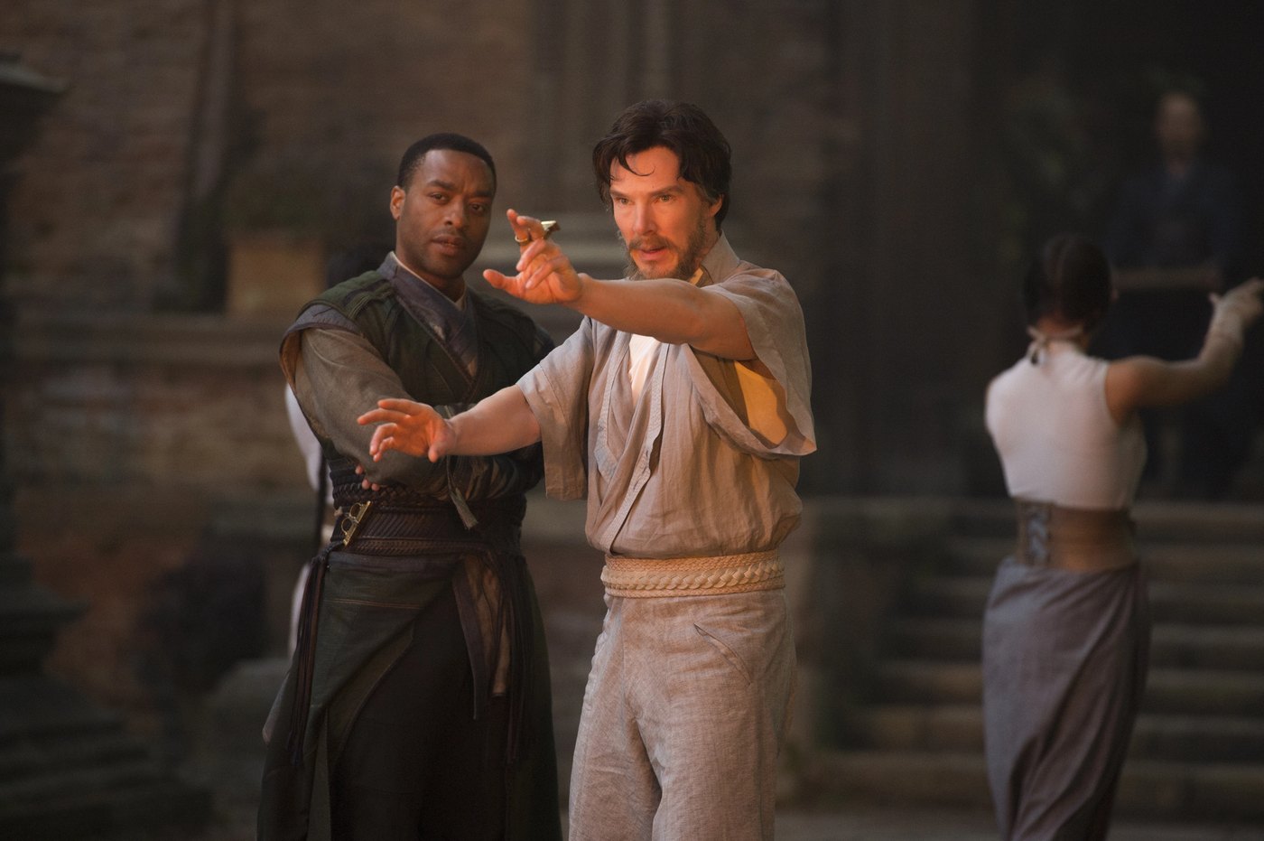 Karl Mordo guiding Stephen Strange through a defensive stance during sling ring training at Kamar-Taj