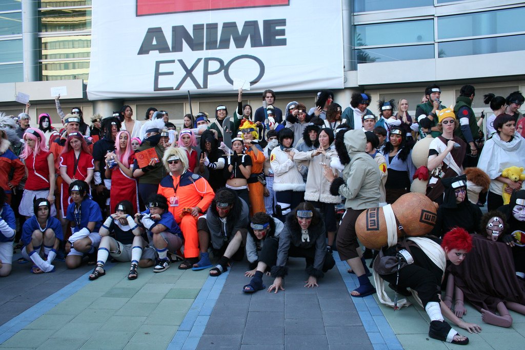 A large group of Naruto cosplayers posed at Anime Expo