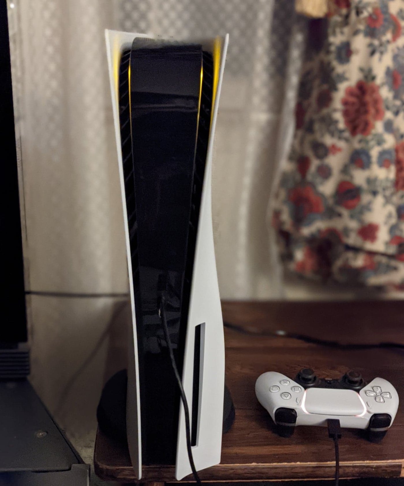 A PlayStation 5 console and DualSense controller; PS5 parental controls filter by age rating