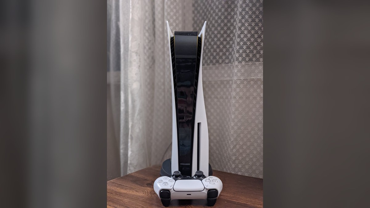 A PlayStation 5 console with a DualSense controller