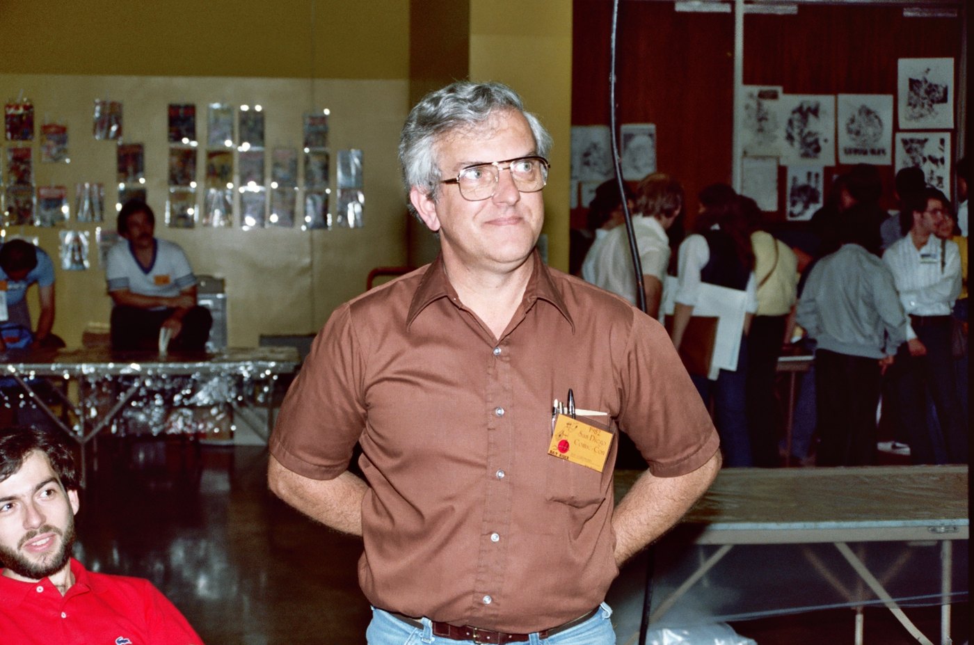 Robert Overstreet at the 1982 San Diego Comic-Con, wearing a name badge among bagged comics