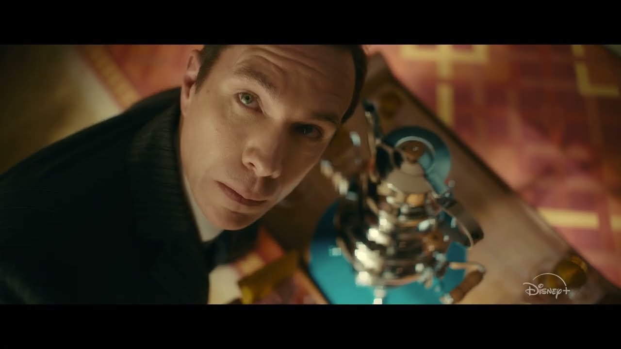 A character beside an ornate mechanism in the VisionQuest trailer