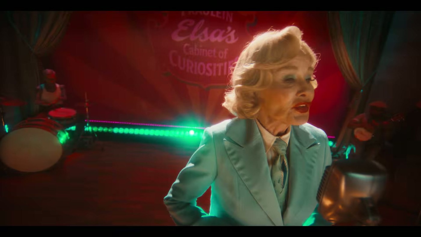 Jessica Lange as Elsa Mars performs on stage under a sign reading Fraulein Elsa's Cabinet of Curiosities in the American Horror Story 13 trailer