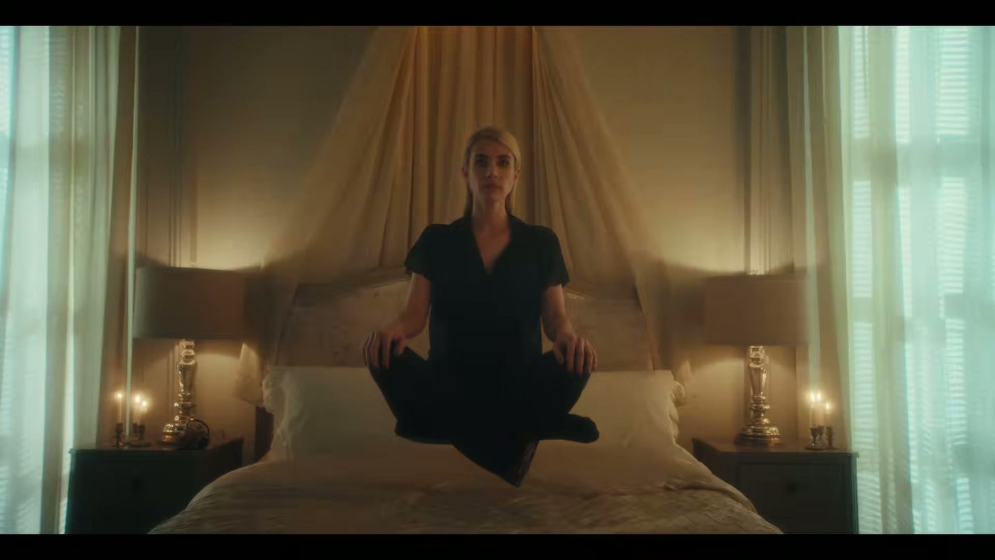 A woman levitating above a bed in the American Horror Story: 13 trailer