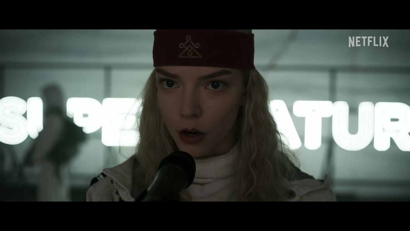 Anya Taylor-Joy as Joan speaking into a megaphone in the Sacrifice trailer