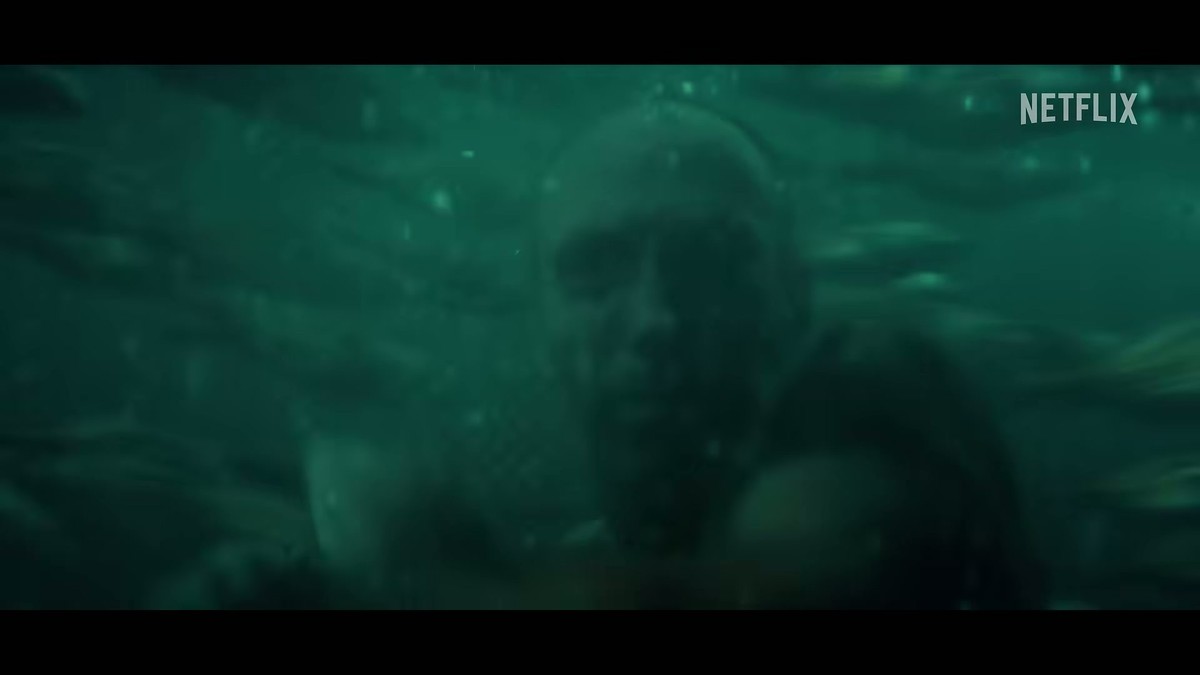 A man submerged and struggling underwater in the Below trailer