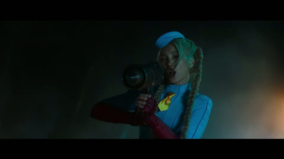 Cammy in a blue leotard with braided blonde hair firing a weapon