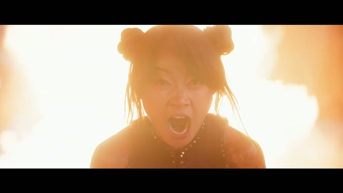Chun-Li with ox-horn buns backlit by fire