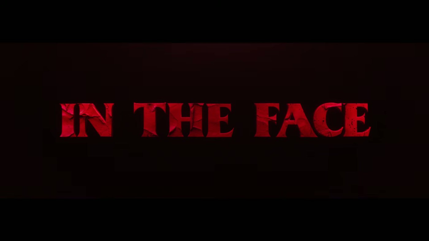 Red text on black reading IN THE FACE, part of the Clayface trailer tagline