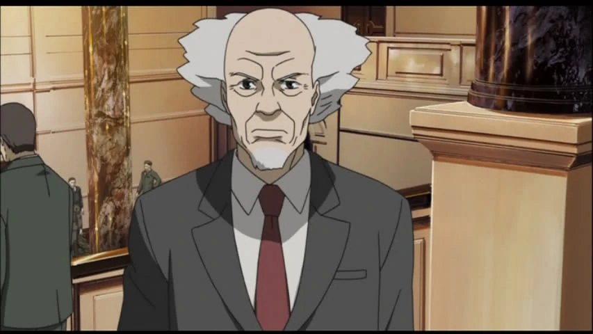 Daisuke Aramaki chief of Public Security Section 9 in a suit
