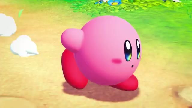 Kirby standing in a green open field in Kirby and the World Beyond