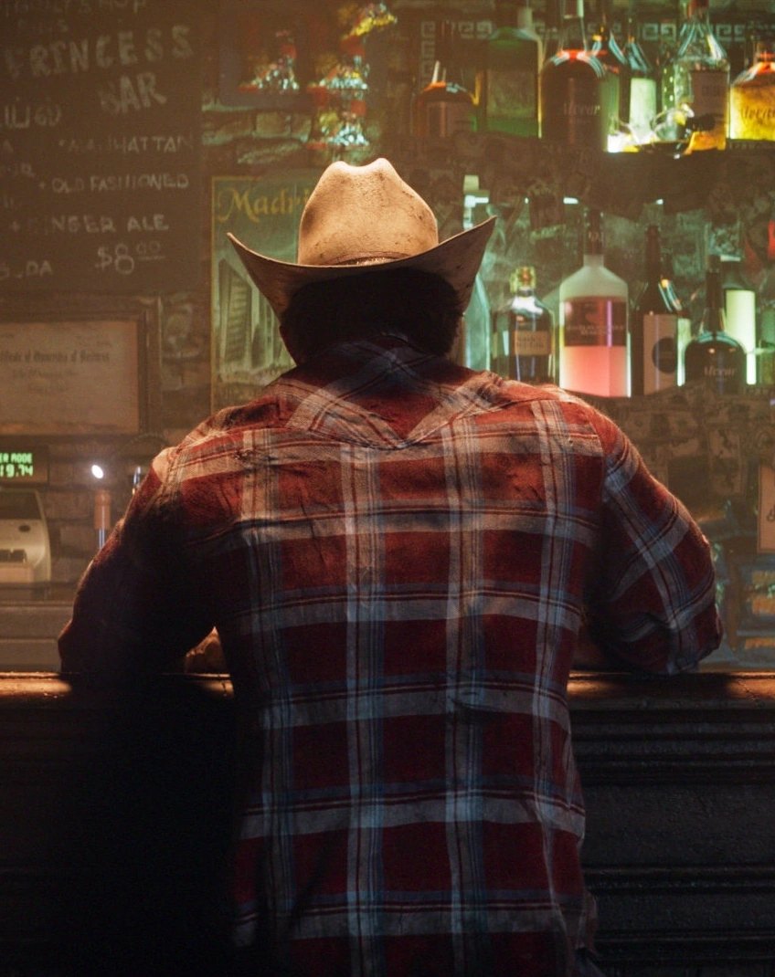 Logan standing at a bar in plainclothes in a Marvel's Wolverine screenshot