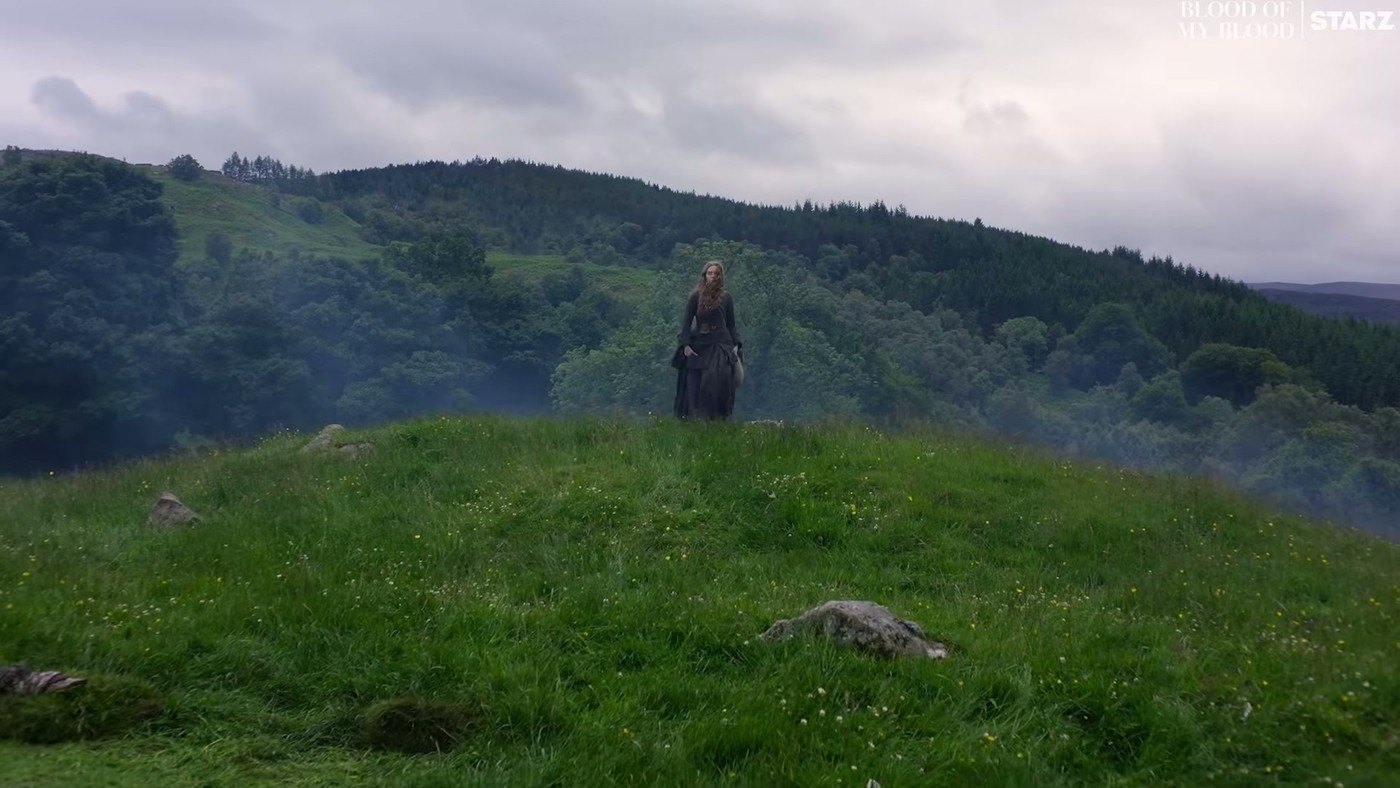 A lone figure on a Highland hillside in Outlander: Blood of My Blood
