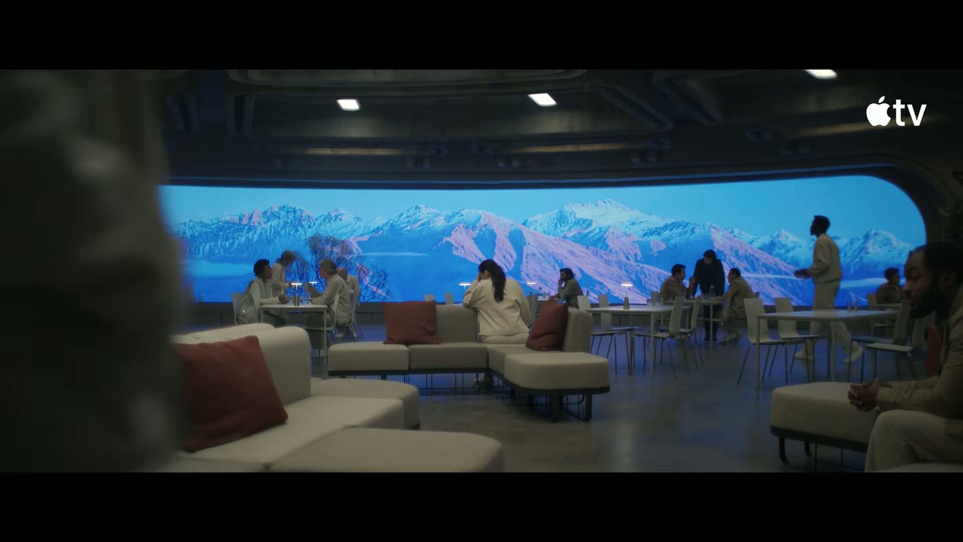 A brightly lit lounge with a giant outdoor-scenery screen in the Silo Season 4 teaser