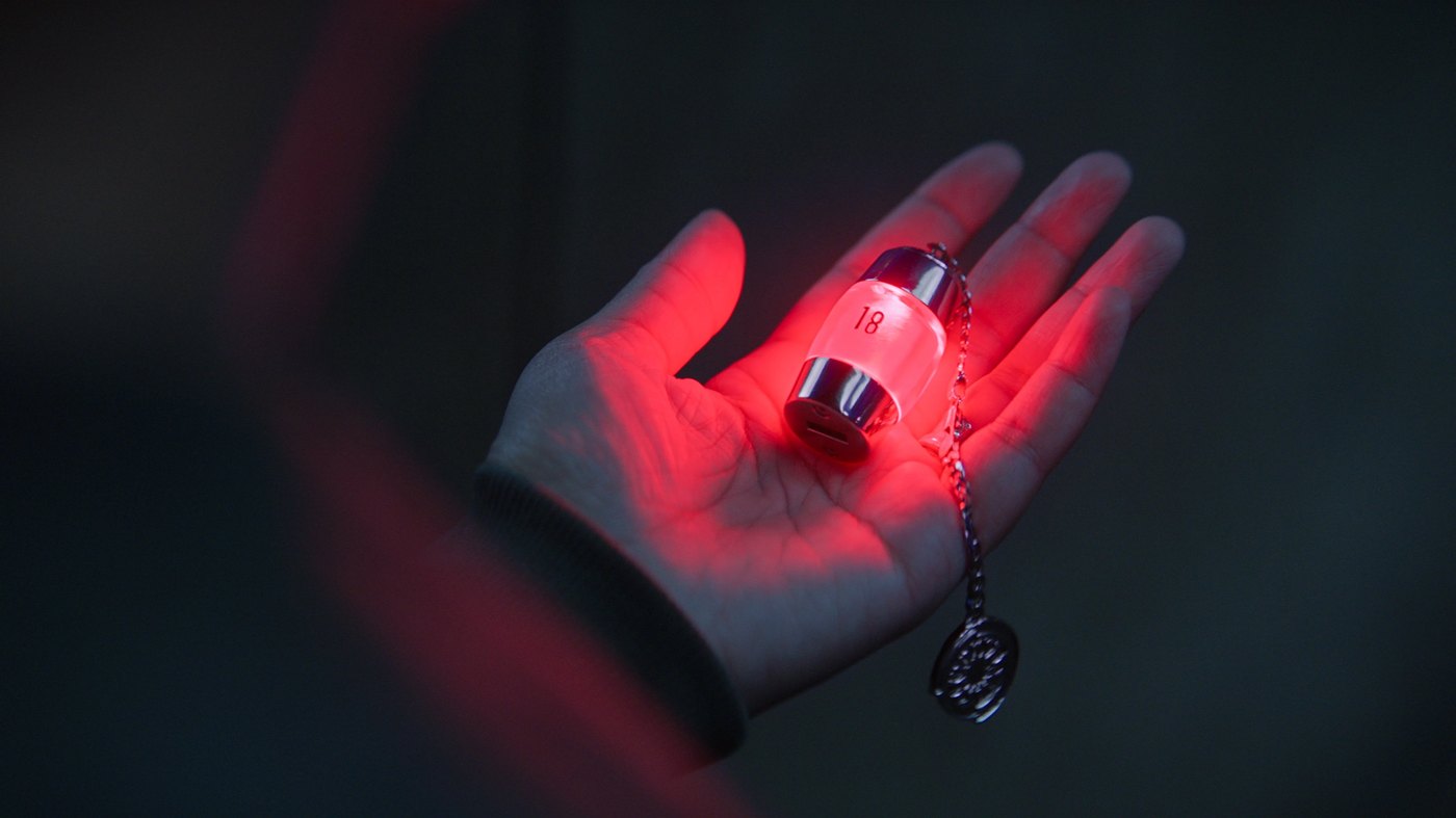 A glowing pendant tied to the Troy identity in Silo season 3