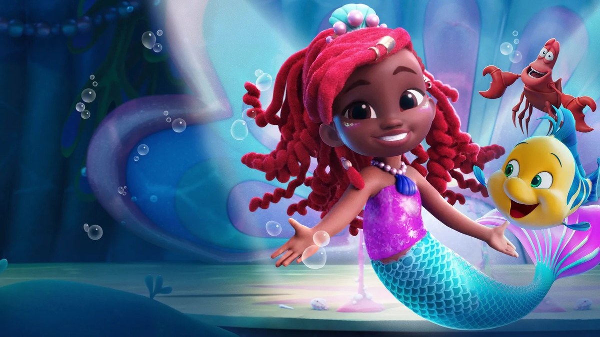 Promotional graphic for the Disney Junior animated series Disney Junior's Ariel, showing the young mermaid Ariel with red locks swimming happily alongside Flounder and Sebastian in an underwater kingdom.