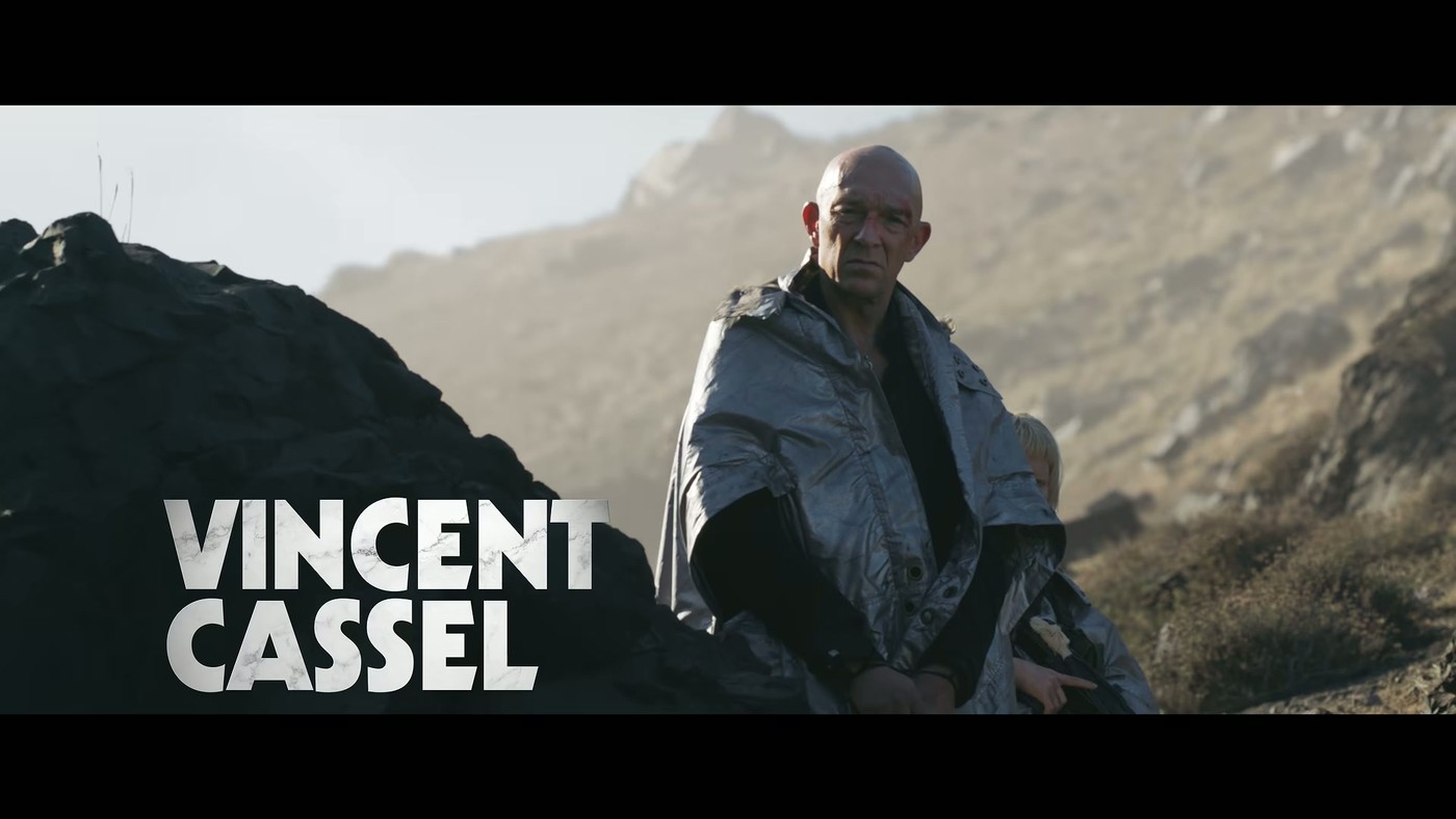 Vincent Cassel wrapped in a shawl on a cliffside, cast card from the Sacrifice trailer