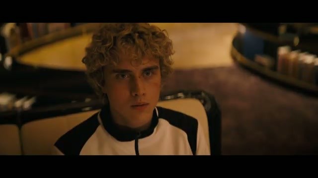 Haymitch Abernathy in a white racing outfit looking startled