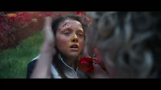 A bloodied Maysilee Donner reaching toward her face in the arena