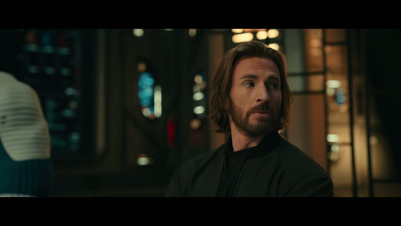 Chris Evans in a dark jacket looking off-screen in a close-up shot from the Avengers: Doomsday trailer