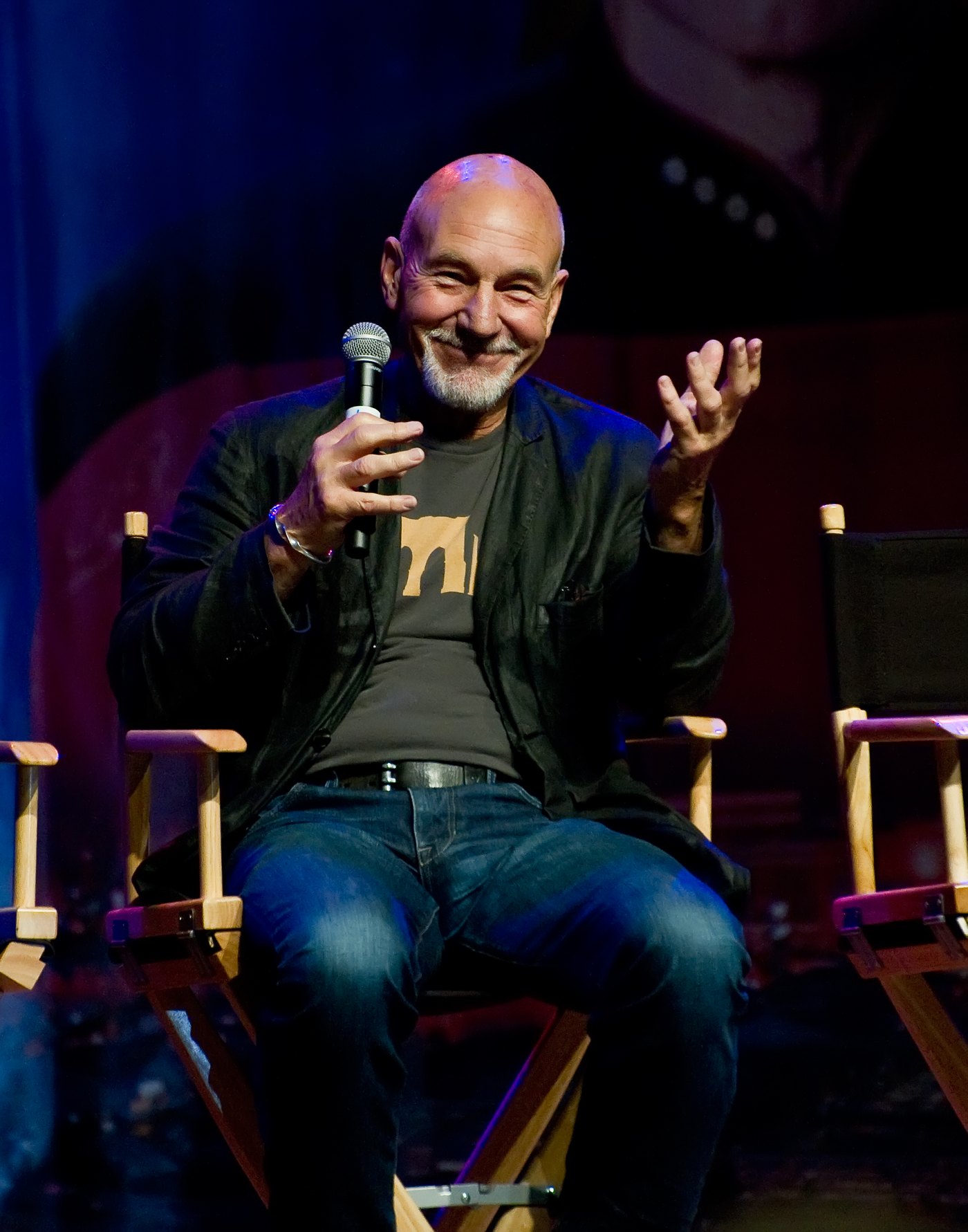 Patrick Stewart speaking on stage at a Star Trek fan convention