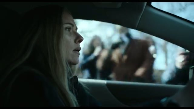 Scarlett Johansson as detective Julie Miller, driving and looking alarmed