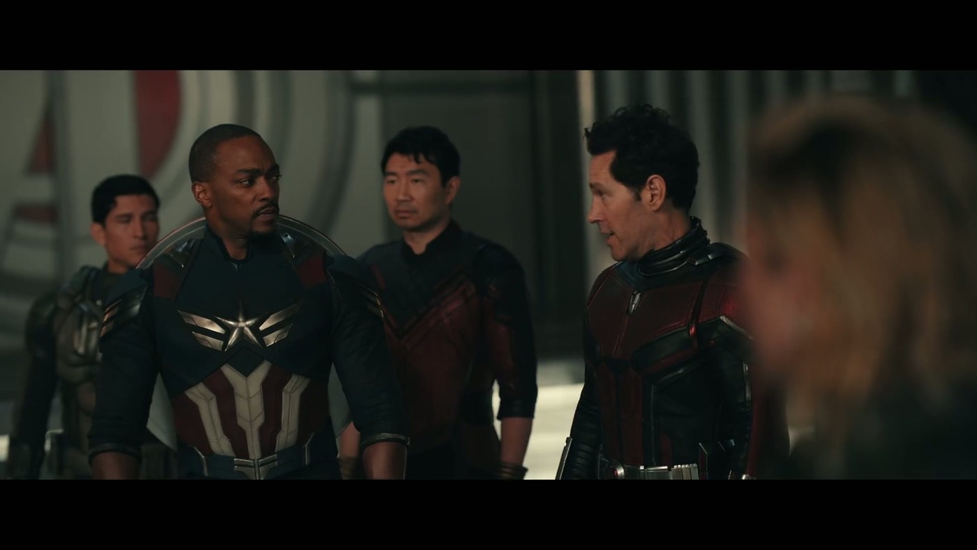 Five heroes standing in formation including Anthony Mackie's Captain America with the white star chest emblem, in the Avengers: Doomsday trailer