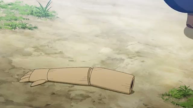 A severed wooden puppet arm on the ground